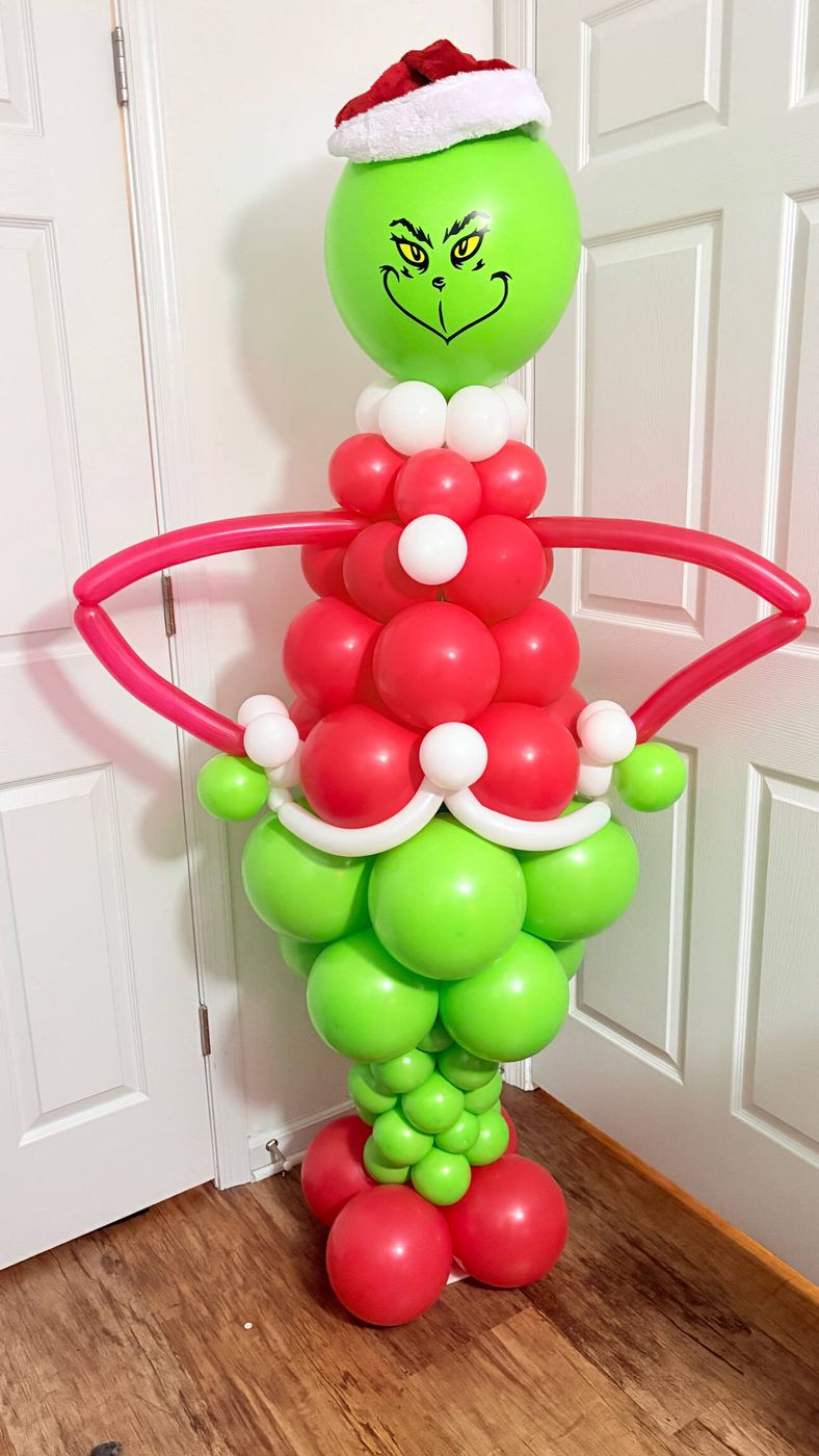 Grinch character built from green, red and white balloons